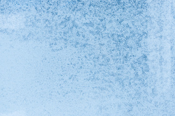 Fototapeta na wymiar The pattern on the window. Background of frozen glass. Frosty window texture.