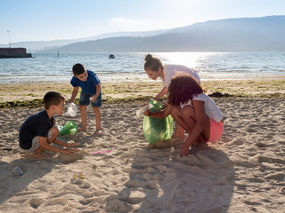 children collecting plastic and rubbish on the beach
