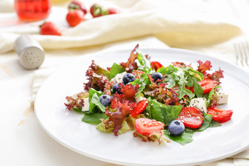 Plate with fresh tasty salad on table, closeup