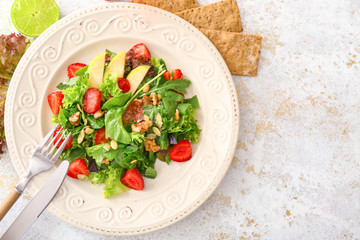 Plate with fresh tasty salad on table