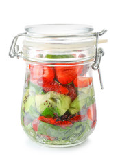 Glass jar with fresh tasty salad on white background