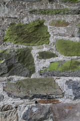 Closeup of vintage stone wall of public park. Vertical view.