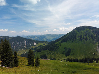 Fototapeta na wymiar Beautiful alpine landscape with green meadows, alpine cottages and mountain peaks, Tyrol Alps, Austria