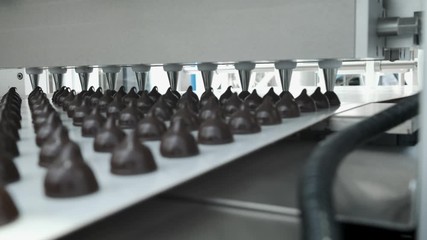 Chocolate candy bars production - food industry process. A lot of chocolates on the production line.