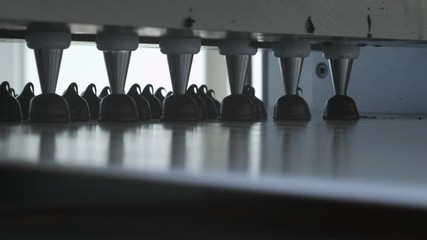 Chocolate candy bars production - food industry process. A lot of chocolates on the production line.