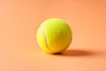 Tennis ball on orange abstract background