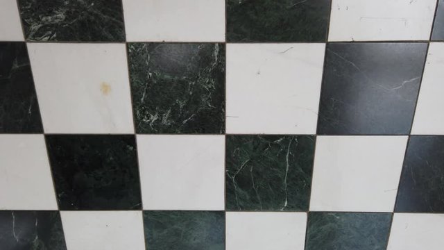 Black and white checkered floor pattern shifting glossy stone material background surface.