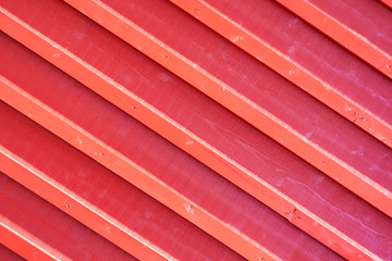 Texture of a beautiful red wooden wall. Backgrounds.