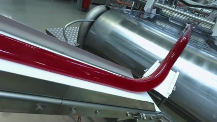 Manufacture of caramel candies. making lollypop. Production of caramel sweets. Lollipops on the production line. Long caramel mass.