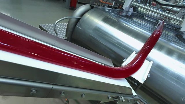 Manufacture of caramel candies. making lollypop. Production of caramel sweets. Lollipops on the production line. Long caramel mass.