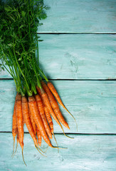 fresh carrots on wooden surface