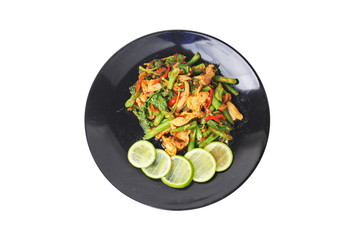 Thai cuisine , Spicy fried cowpea and basil with pork topped sliced green lemon on black plate
