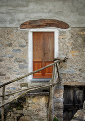 Old Wooden Door on a Stone Building in Italy