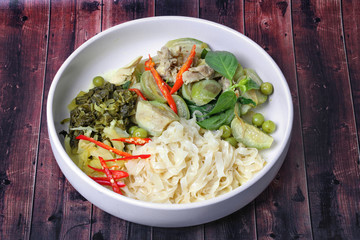 Popular Thai food, Chinese noodle with green chicken curry in coconut milk topped herb .