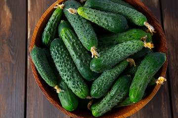 cucumbers in a bowl on wooden surface