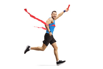Man on the finish line of a marathon race with a baton in his hand