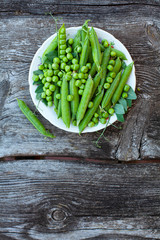 fresh pea on dark wooden surface