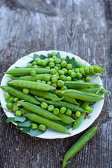 fresh pea on dark wooden surface