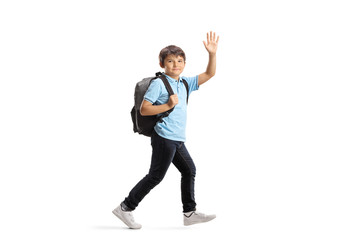 Schoolboy with a backpack running and waving at the camera