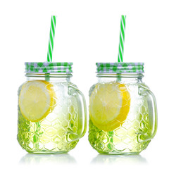 Mason jar glass with lemon water on white background isolation