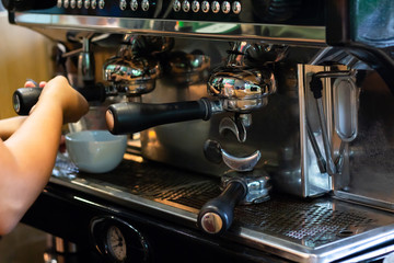 Barista make coffee latte art with espresso machine in cafe 