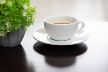 White coffee cup on a brown table in  cafe