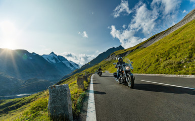 Motorcycle driver riding in Alpine highway, Nockalmstrasse, Austria, Europe.