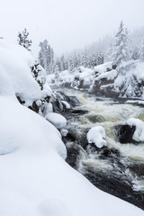 Snowy scenic landscape of a flowing river in Yellowstone National Park