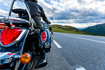 Obraz premium Motorcycle driver riding in Alpine highway, Nockalmstrasse, Austria, Europe.