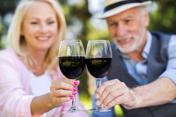 Lovely couple holding two glasses of wine