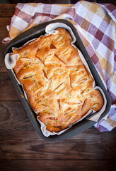 Fresh cakes. Apple pie on a wooden table. Country style..