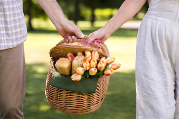 Couple holding a picnic basket