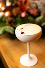 Close-up white cocktail on the bar, blurred background.