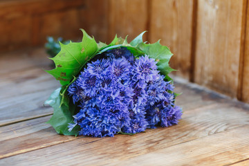 Cornflower flower. Blue beautiful flowers lie on the table. Bouquet of wildflowers.