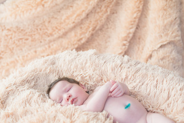 newborn sleeping on a soft blanket. gentle sleeping newborn baby on a light background