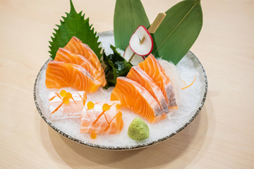 Fresh salmon slice sashimi serve on ice with wasabi Japanese style