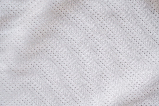 White fabric sport clothing football jersey with air mesh texture background