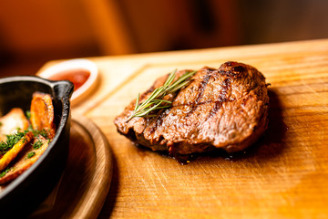 Grilled Tomahawk steak ribeye with rosemary on wooden plate