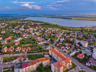Aerial view of Slatina city and river Olt, Romania. Drone flight over the european city in summer day. © Igor Syrbu