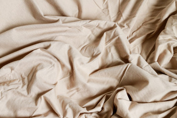 Beige bedsheet background.