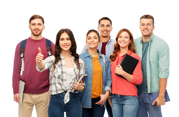 Obraz premium education, high school and people concept - group of smiling students with books showing thumbs up over white background