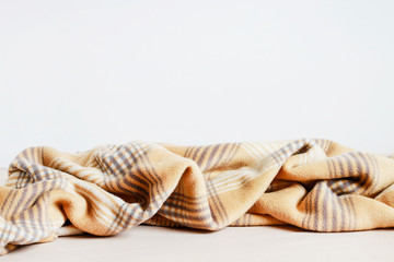 Beige blanket and bedsheet.