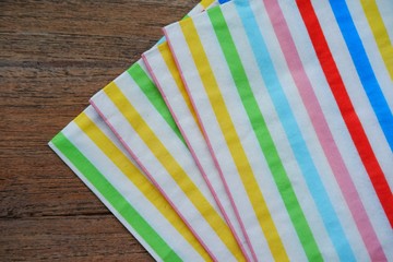 colored napkin paper on wooden background