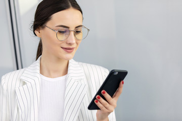 Business Woman Using Phone Near Office