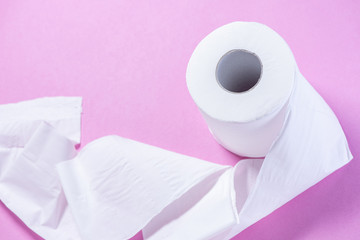 Eco-friendly white toilet paper on a pink background close-up