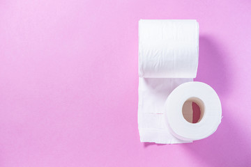 Eco-friendly white toilet paper on a pink background close-up