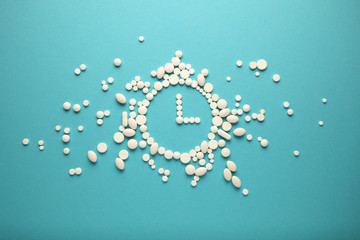 Clock from pills, vitamins for elderly. Treatment time.