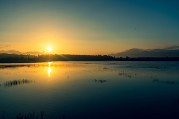 Naklejka na ściany i meble Sunrise view at the reservoir in Songkhla, Thailand.
