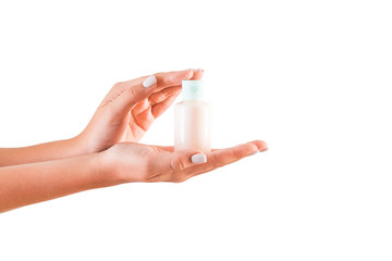 Female hand holding cream bottle of lotion isolated. Girl give tube cosmetic products on white background