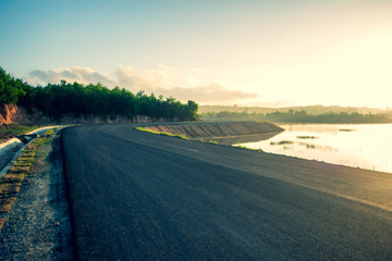 view of road way along side with reservoir at Nathongsuk reservoir, Songkhla, Thailand. (Selective focus)